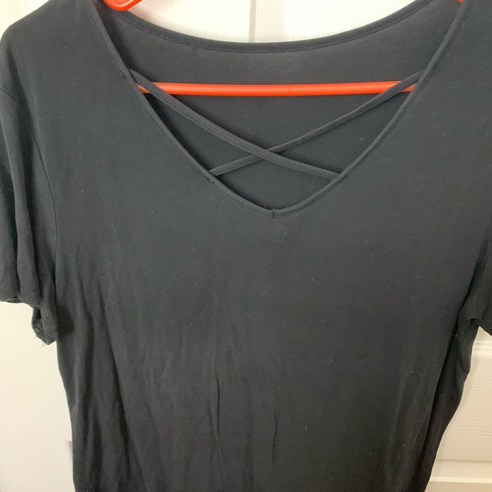 Black shirt with criss cross detail in the front. Super cute and super comfy!!
